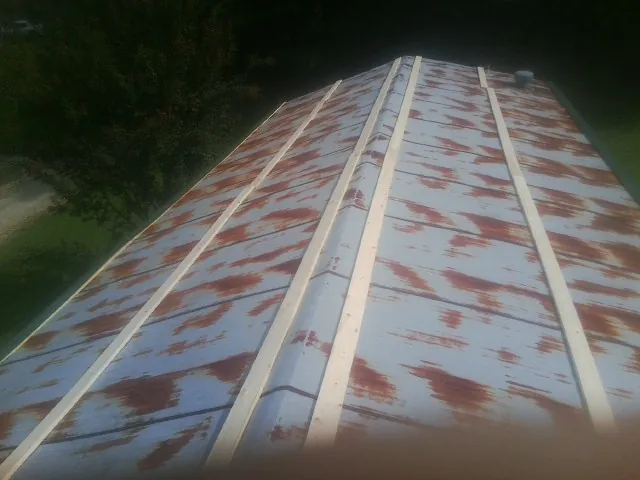 Rusted metal roof panels with new wood purlins before replacement — Storm Damage Roof Repair in Huntington Park by Roofing Brothers