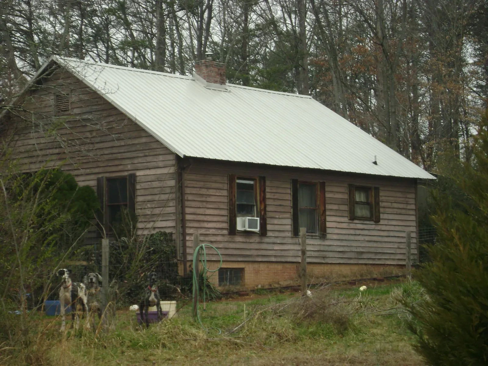 White metal roof on an old wood sided farmhouse, from a Asphalt Shingle Roof Repair job in Huntington Park